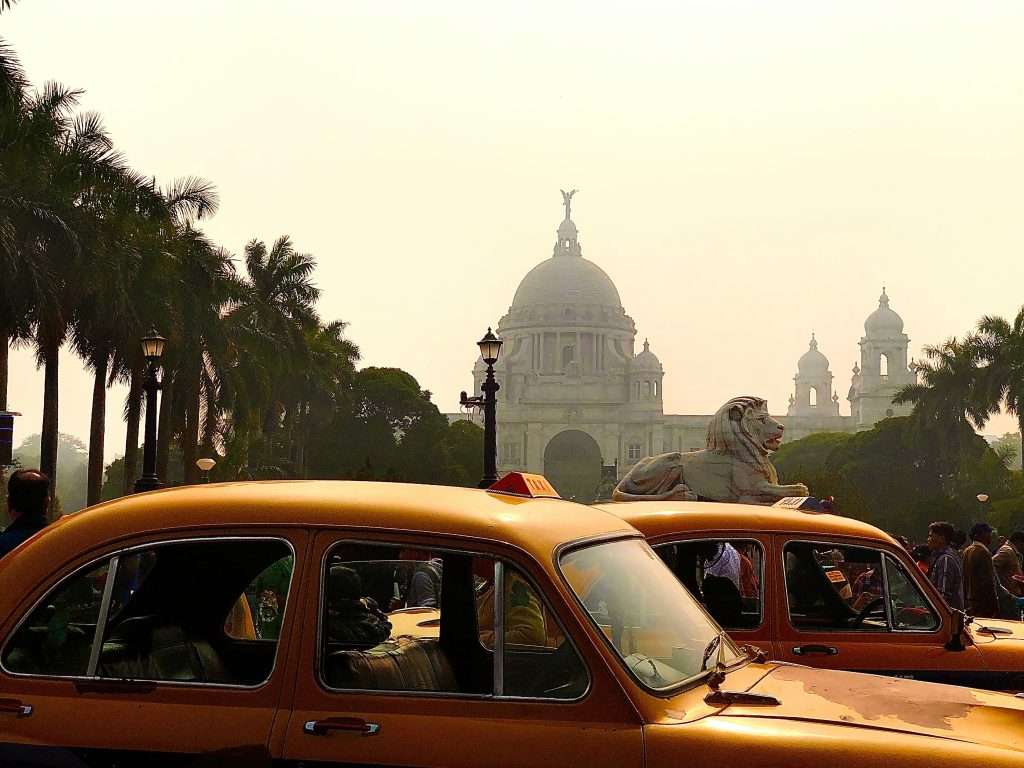 A traditional yellow taxi in Kolkata